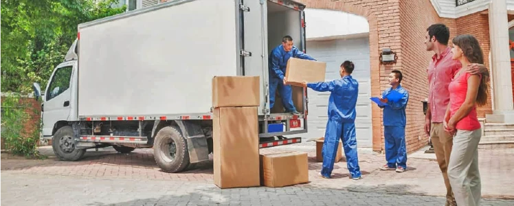 Movers packing boxes into a van