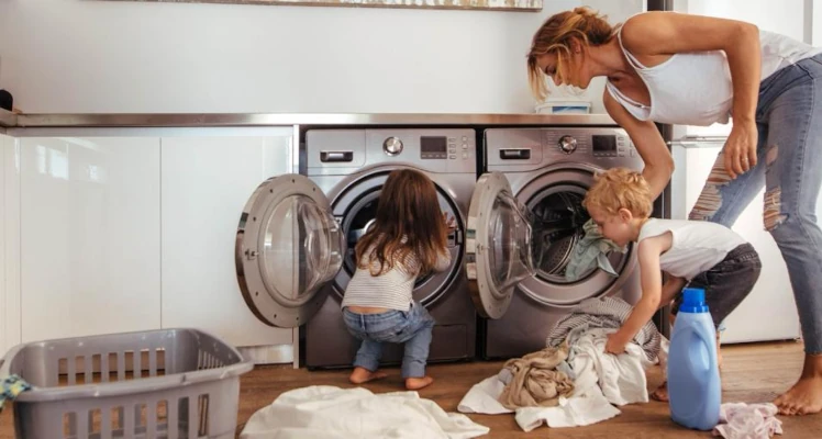 A couple scrubbing their home in cleaning clothes